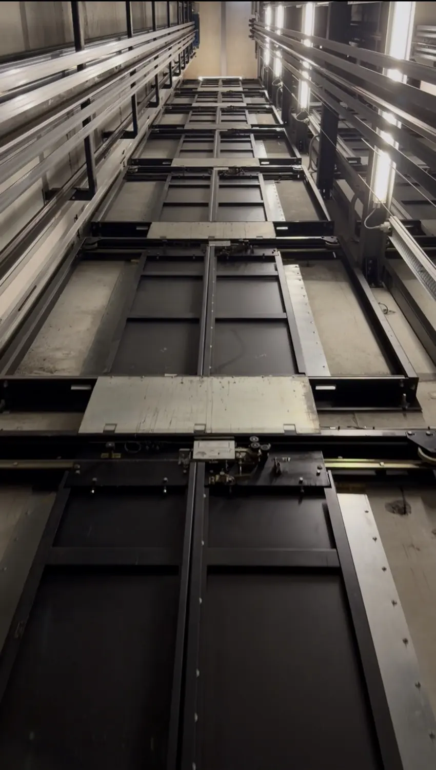 Looking up a lift shaft past the landing doors of each floor